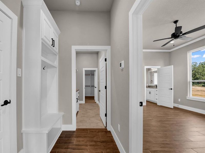 Mudroom with wood finish floors, a ceiling fan, and crown molding