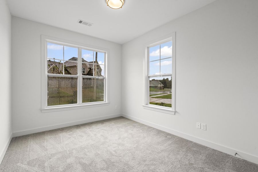 Spare room with light carpet and plenty of natural light