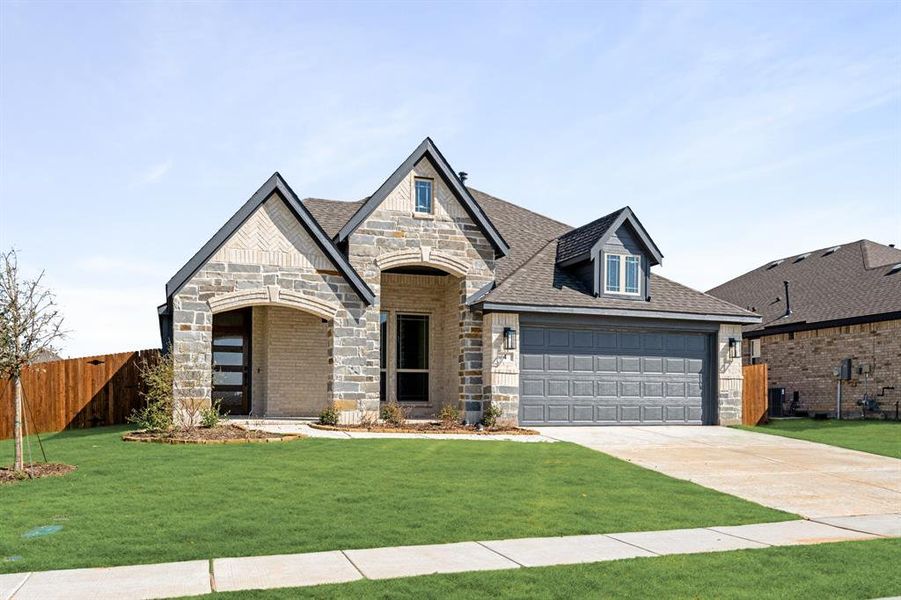 Front exterior of a new home in Sable Creek, Sanger, TX, highlighting curb appeal (Image 1).