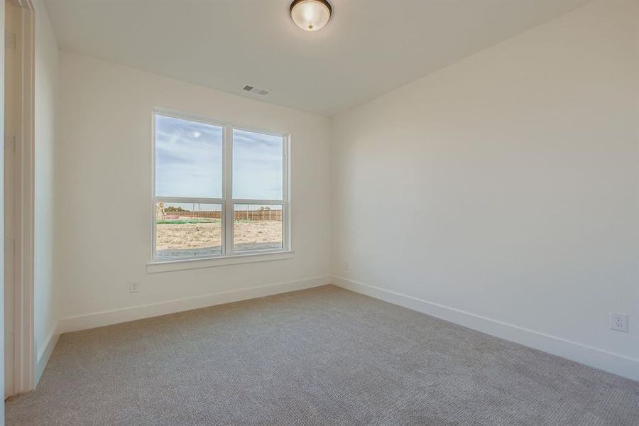 Unfurnished room featuring carpet flooring and a water view Unfurnished room featuring carpet flooring and a water view