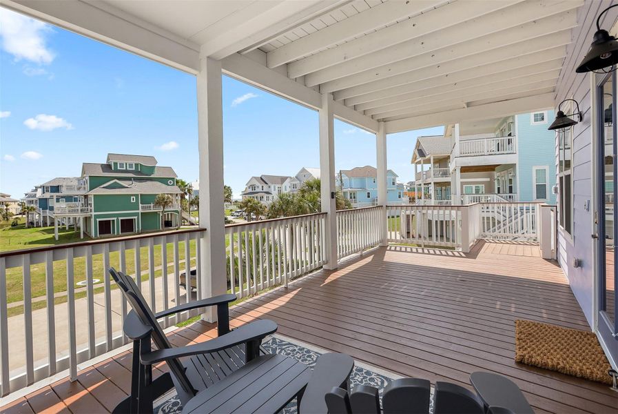 From the lower balcony, take in peaceful Gulf views and the surrounding resort-style community. This inviting outdoor space is ideal for gatherings or quiet moments of retreat.