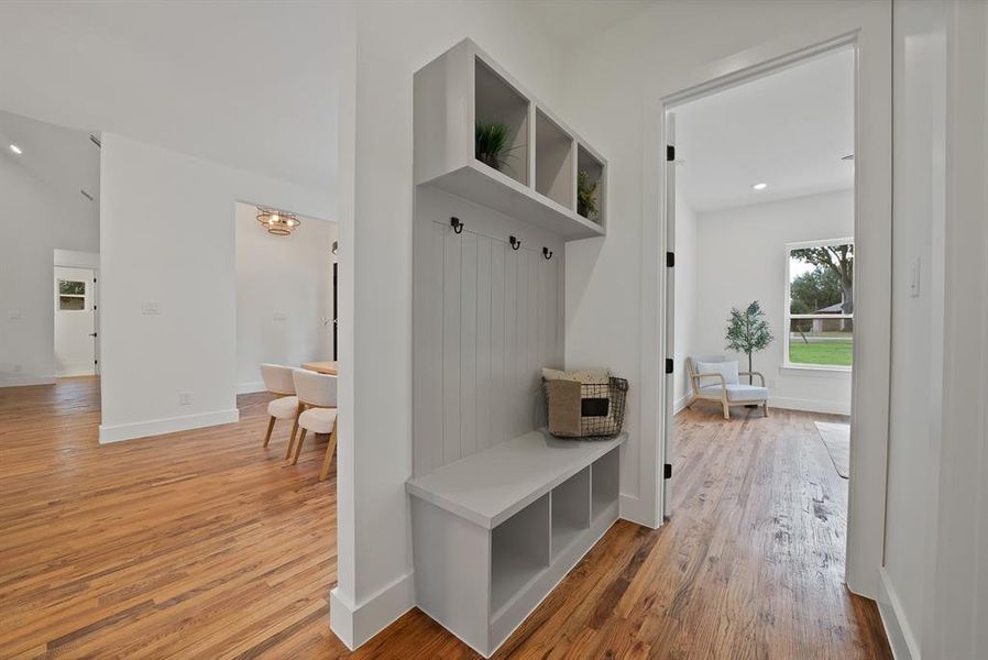 Mudroom featuring light wood-style flooring, recessed lighting, and a chandelier Mudroom featuring light wood-style flooring, recessed lighting, and a chandelier