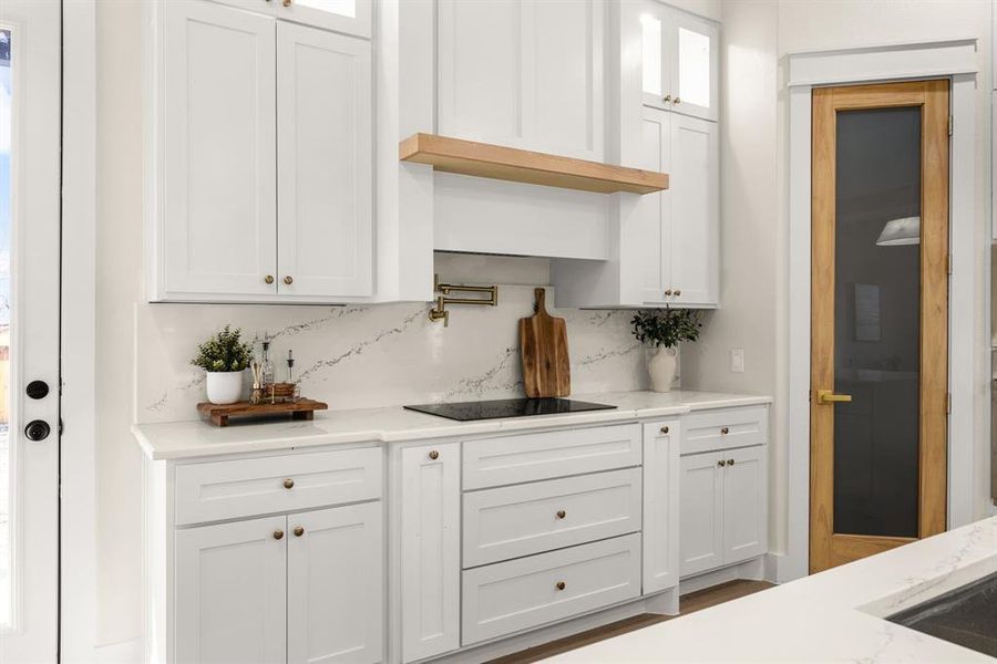 Bar with black electric cooktop and backsplash