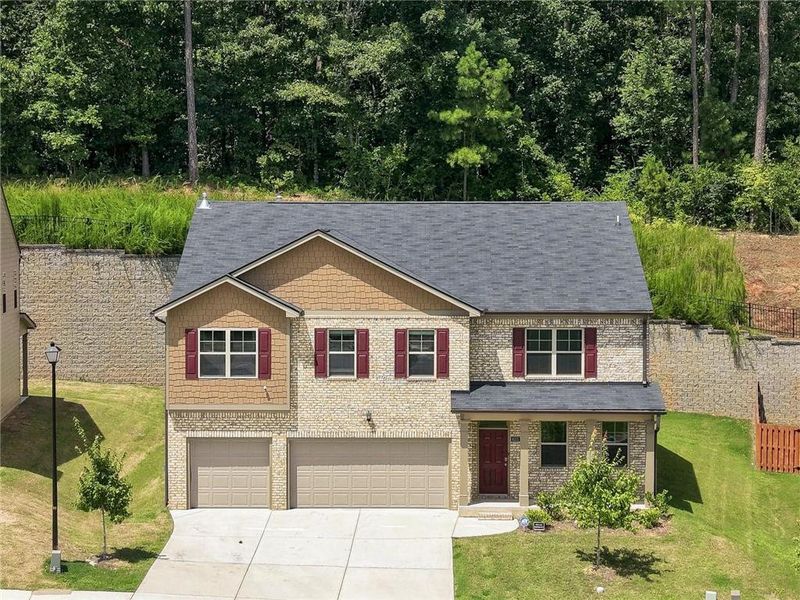 Front exterior of a new home in The Enclave at Flat Rock Hills, Stonecrest, GA, highlighting curb appeal (Image 27). Front exterior of a new home in The Enclave at Flat Rock Hills, Stonecrest, GA, highlighting curb appeal (Image 27).