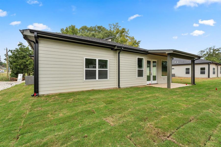 Back of property with a patio and a yard