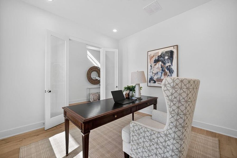 Home office featuring light wood-style floors, recessed lighting, and french doors Home office featuring light wood-style floors, recessed lighting, and french doors