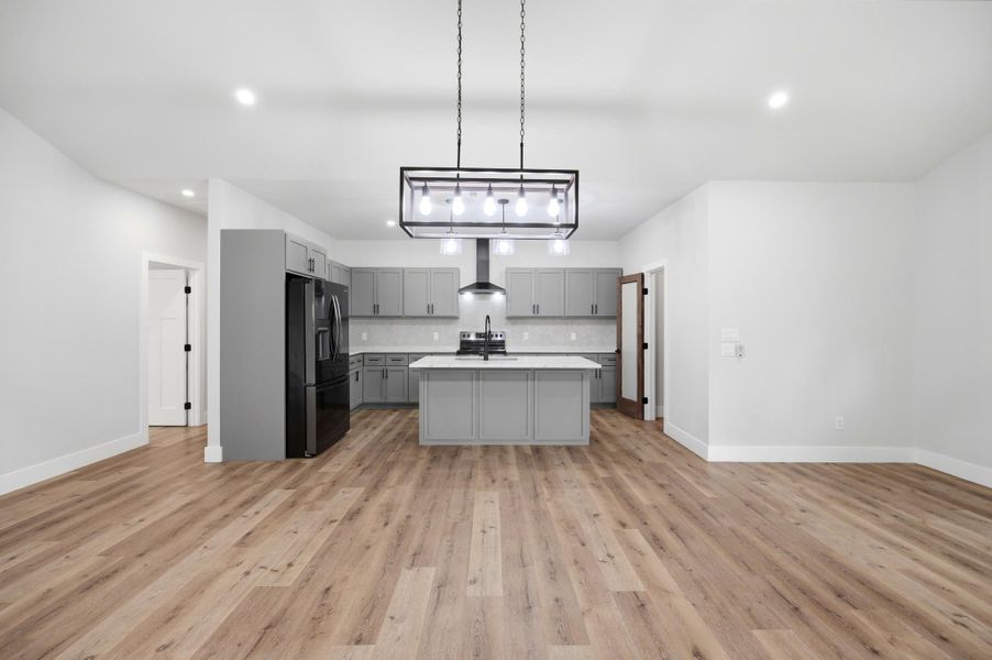 A well-appointed kitchen showcasing contemporary gray cabinetry with soft close features and luminous white granite countertops. A well-appointed kitchen showcasing contemporary gray cabinetry with soft close features and luminous white granite countertops.