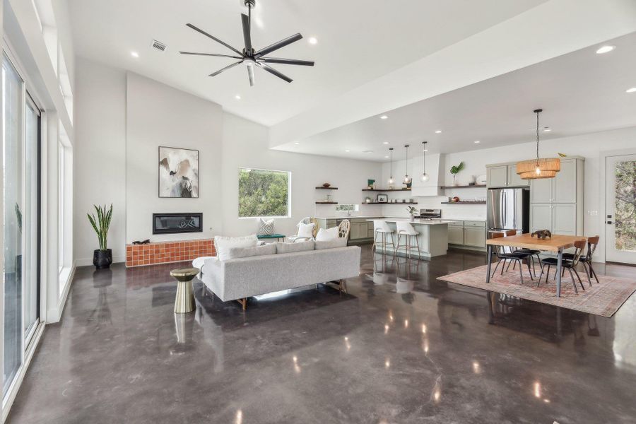 Living area featuring recessed lighting, a ceiling fan, and a high ceiling Living area featuring recessed lighting, a ceiling fan, and a high ceiling