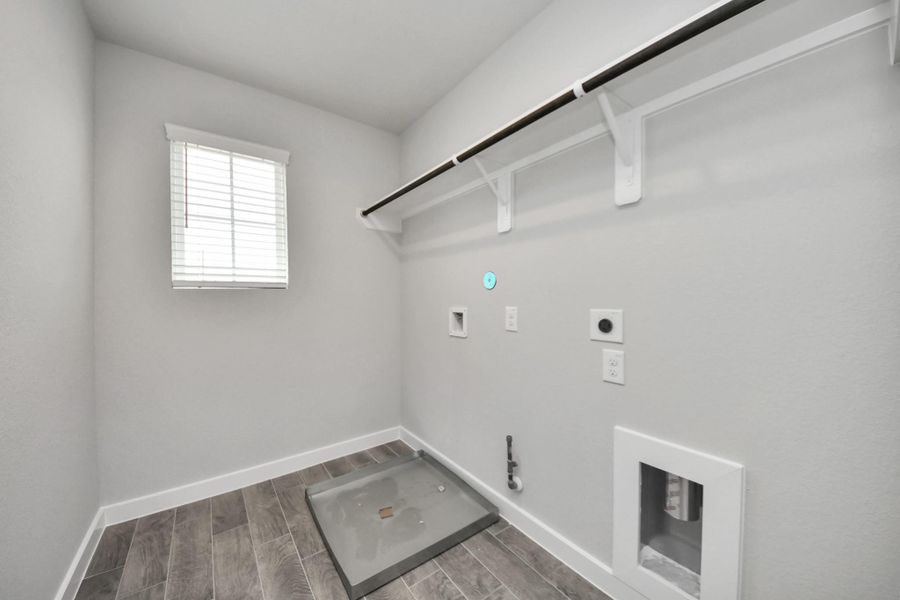 A perfect blend of functionality and comfort. Capture the essence of easy living with a first-floor laundry room, thoughtfully equipped with shelving for effortless organization. Bothelectric and gas connections available.