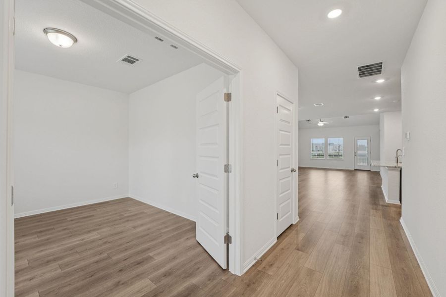 Hall with light wood-type flooring and recessed lighting