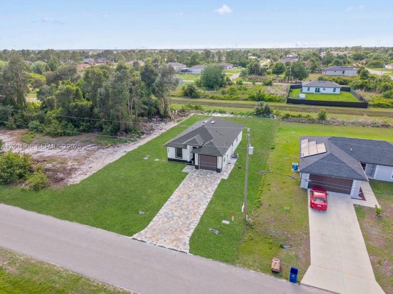 Front exterior of a new home in , Lehigh Acres, FL, highlighting curb appeal (Image 21).