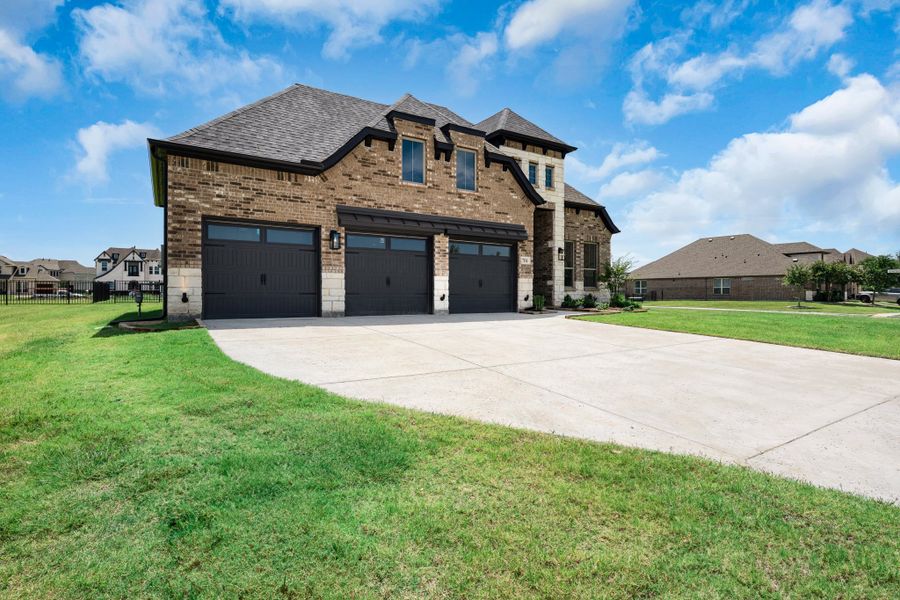 Front exterior of a new home in Heath Golf and Yacht Club, Heath, TX, highlighting curb appeal (Image 18). Front exterior of a new home in Heath Golf and Yacht Club, Heath, TX, highlighting curb appeal (Image 18).