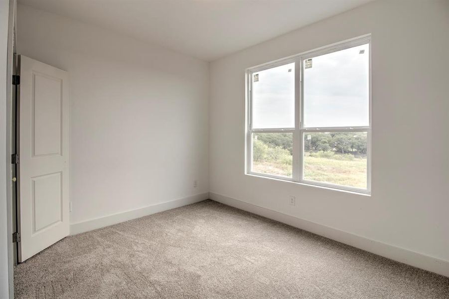 Unfurnished room featuring light carpet and baseboards Unfurnished room featuring light carpet and baseboards