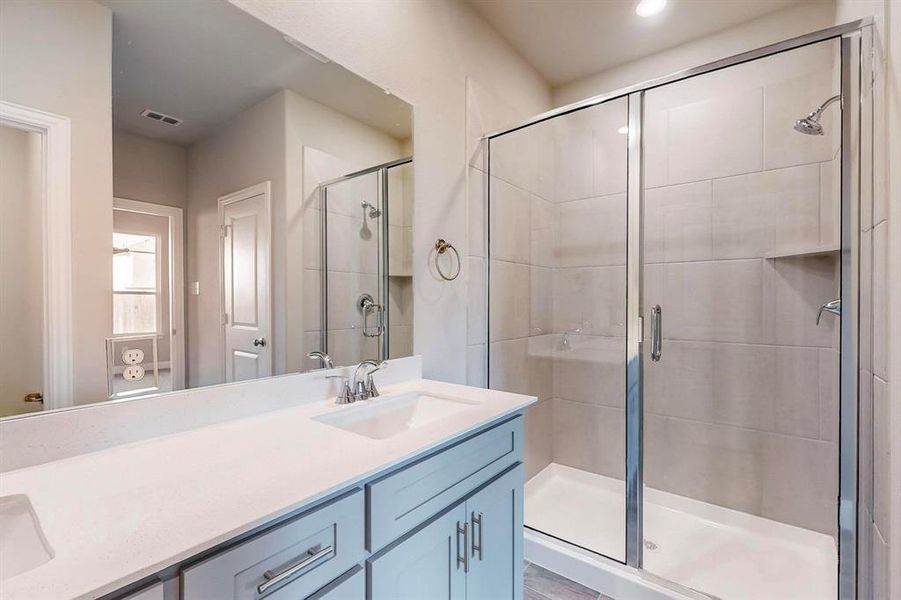 Bathroom featuring vanity and walk in shower