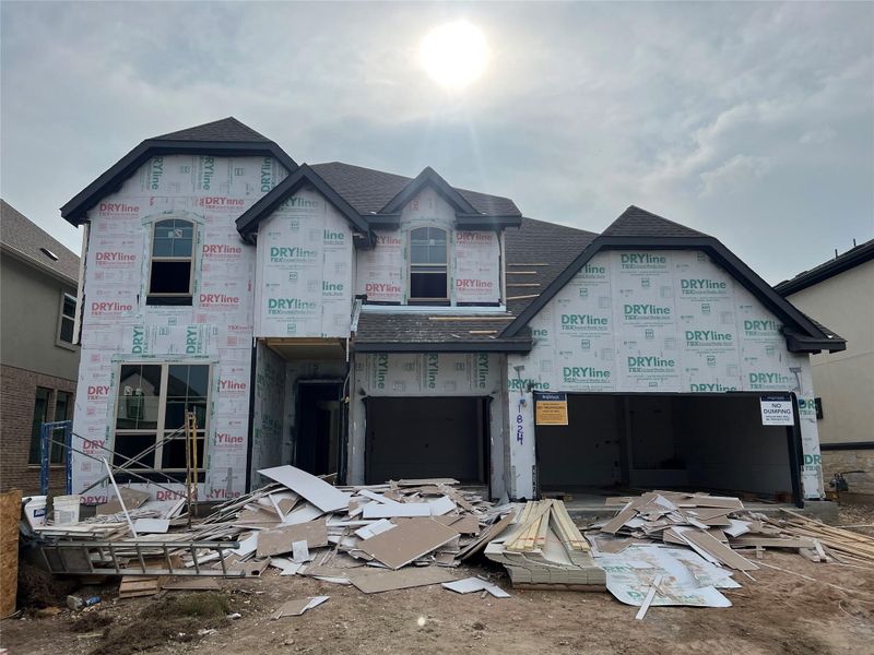 Property in mid-construction featuring a shingled roof