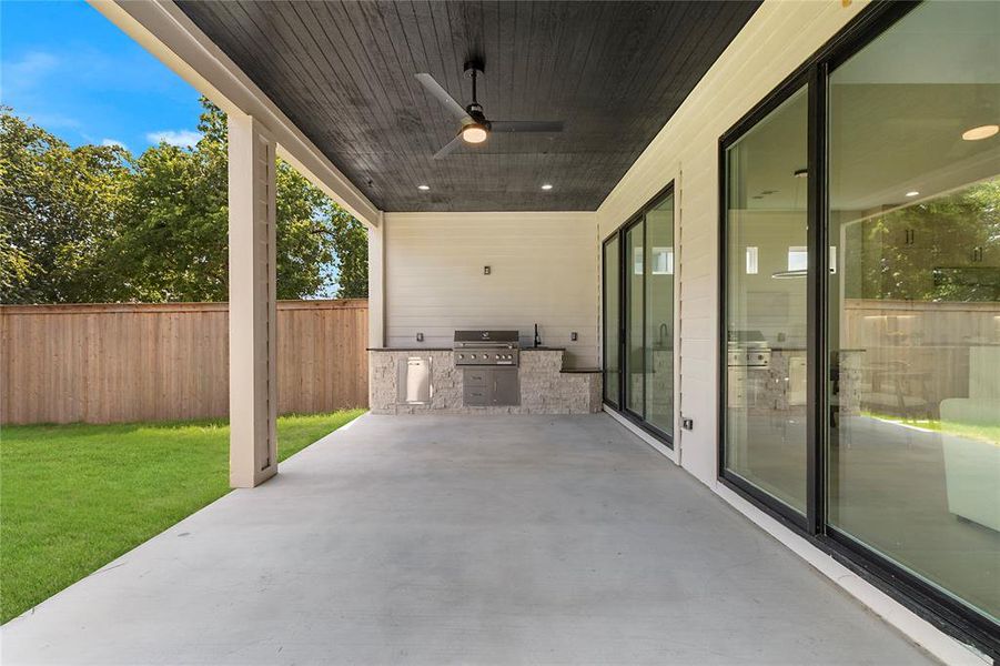 View of patio featuring grilling area and ceiling fan