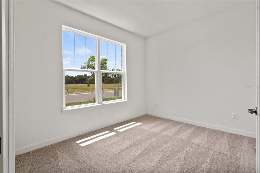 Private study with windows looking to the front yard.