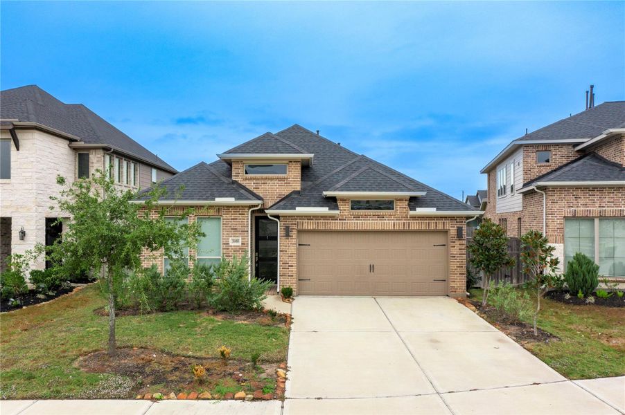 Front exterior of a new home in Cross Creek West 45', Fulshear, TX, highlighting curb appeal (Image 2). Front exterior of a new home in Cross Creek West 45', Fulshear, TX, highlighting curb appeal (Image 2).