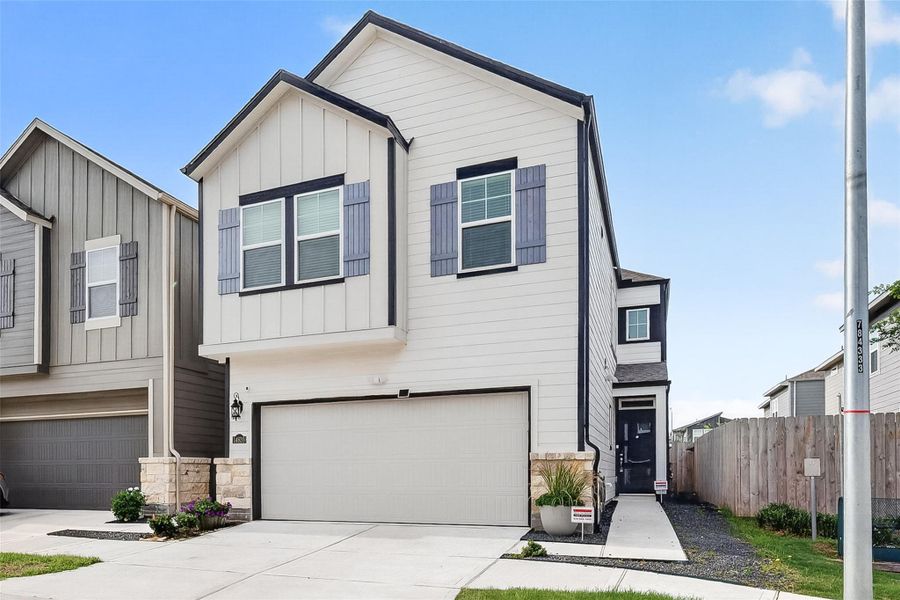 Front exterior of a new home in McClendon Park Village, Houston, TX, highlighting curb appeal (Image 24).