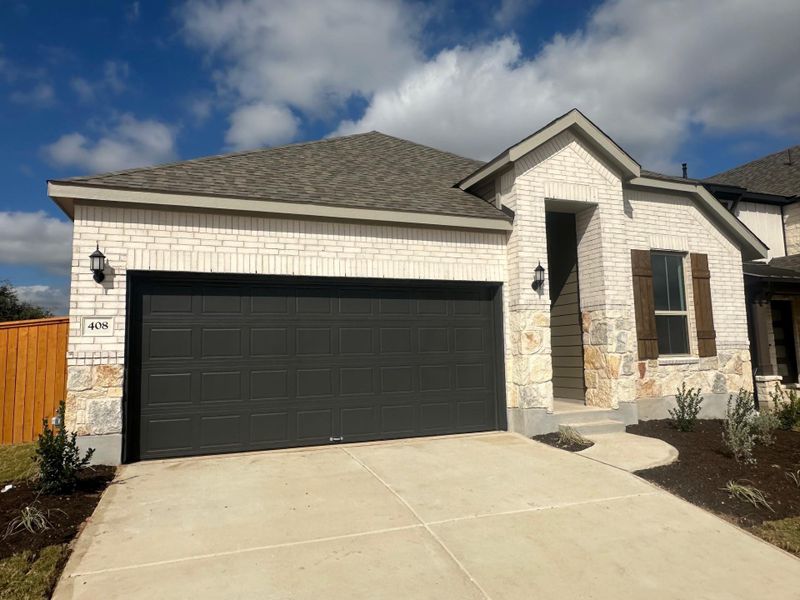 Front exterior of a new home in La Cima, San Marcos, TX, highlighting curb appeal (Image 2).