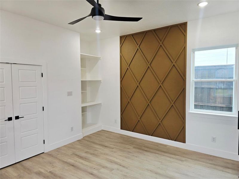Unfurnished room featuring ceiling fan and light wood-style floors
