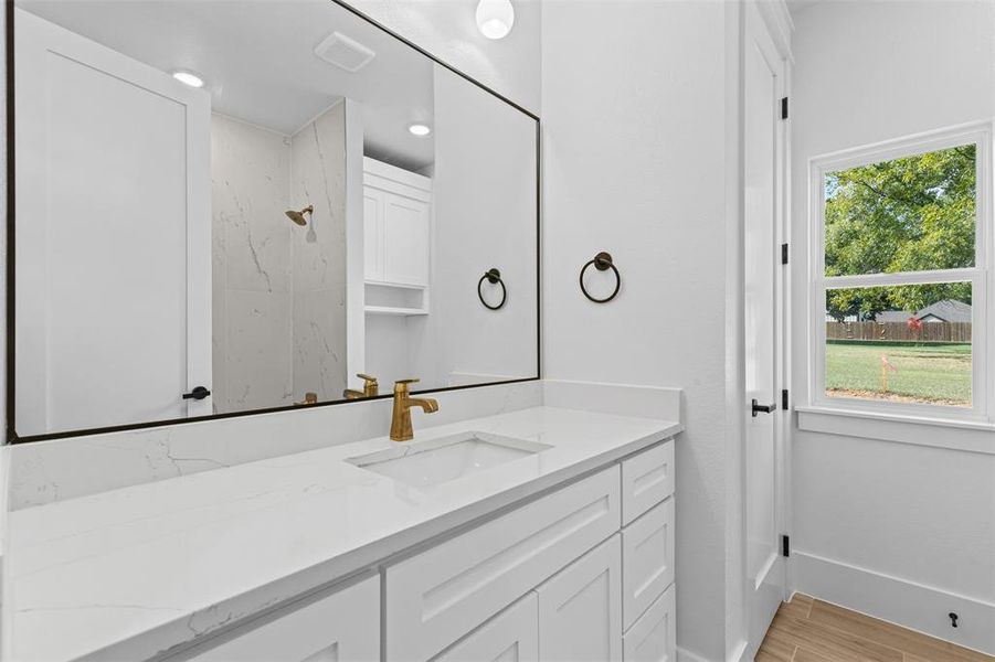 Bathroom featuring vanity and wood finish floors
