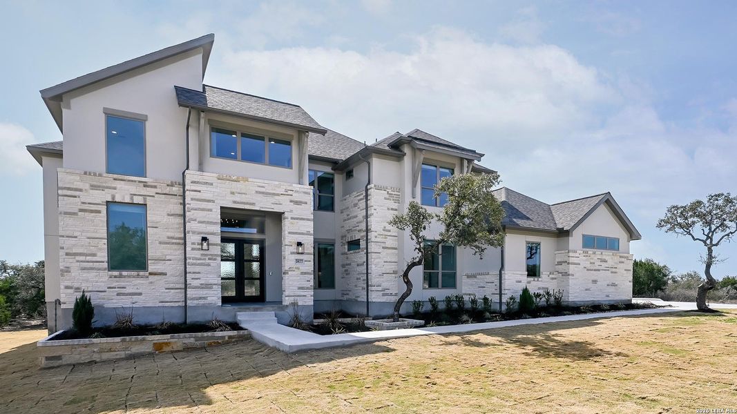 Front exterior of a new home in Johnson Ranch, Bulverde, TX, highlighting curb appeal (Image 18).