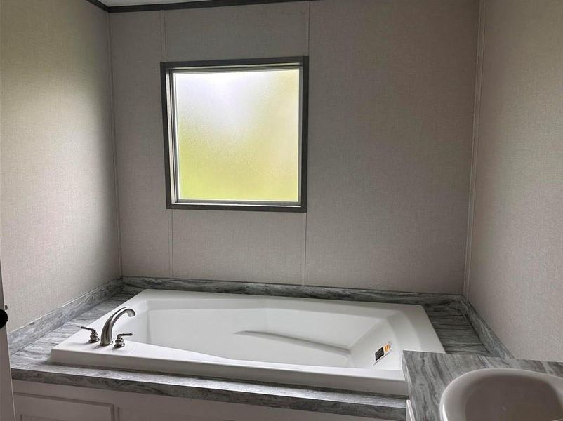 Full bathroom featuring a bath and vanity Full bathroom featuring a bath and vanity