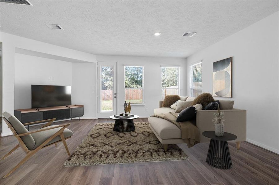 Gather the family and guests together in your lovely family room! Featuring high ceilings, recessed lighting, custom paint, gorgeous vinyl plank floors and large windows that provide plenty of natural lighting throughout the day.