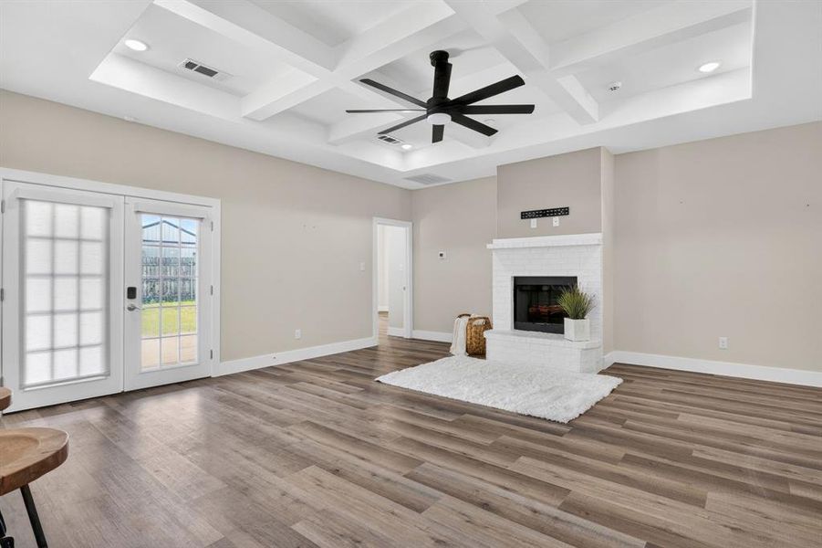Over view of living room and designer ceiling fans, recess lightning, and plenty of natural lightning.