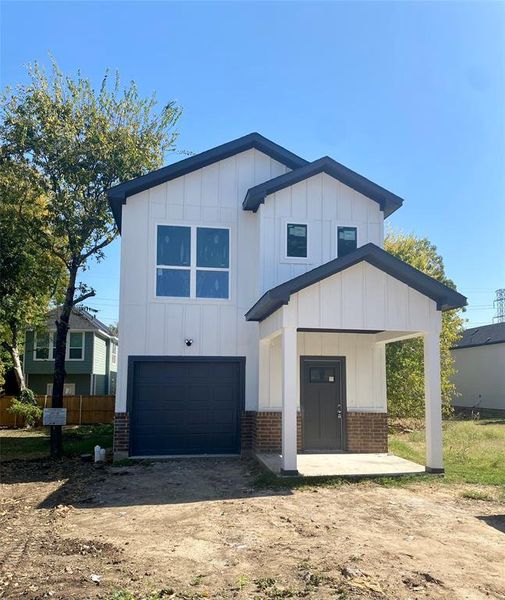 View of front of property featuring a garage