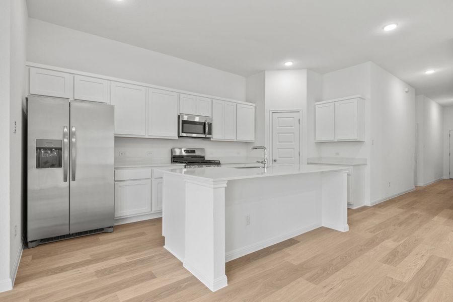 Kitchen in the Quartz home plan by Trophy Signature Homes – REPRESENTATIVE PHOTO