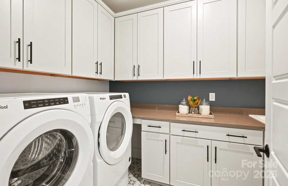 Spacious Laundry room with Cabinets and Sink and Plenty of Space for Future Washer & Dryer.  Representative Photo.