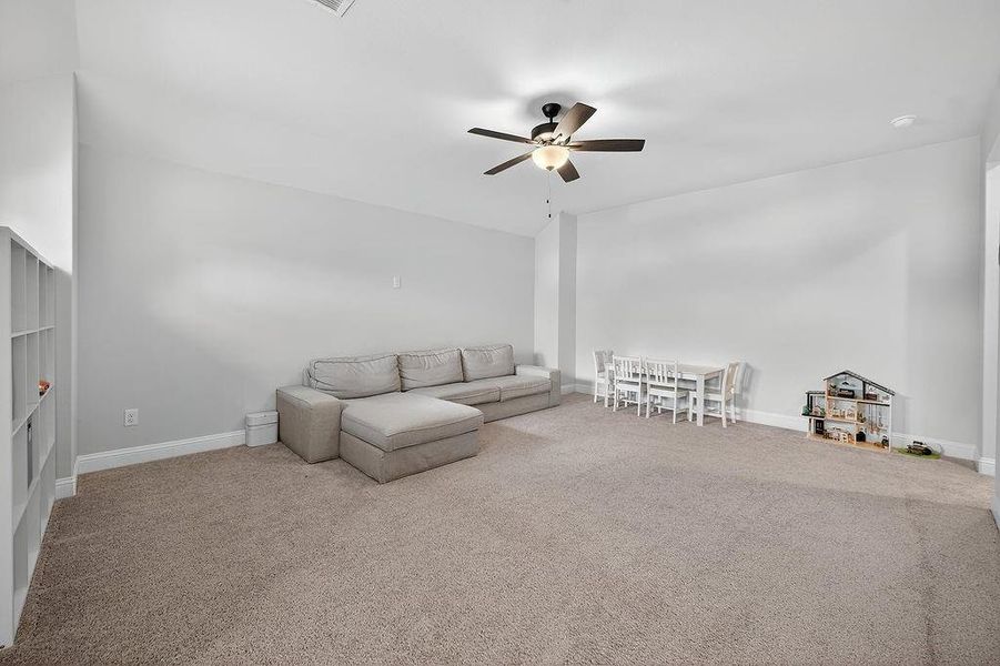 Spacious room featuring neutral carpeting and light-toned walls
