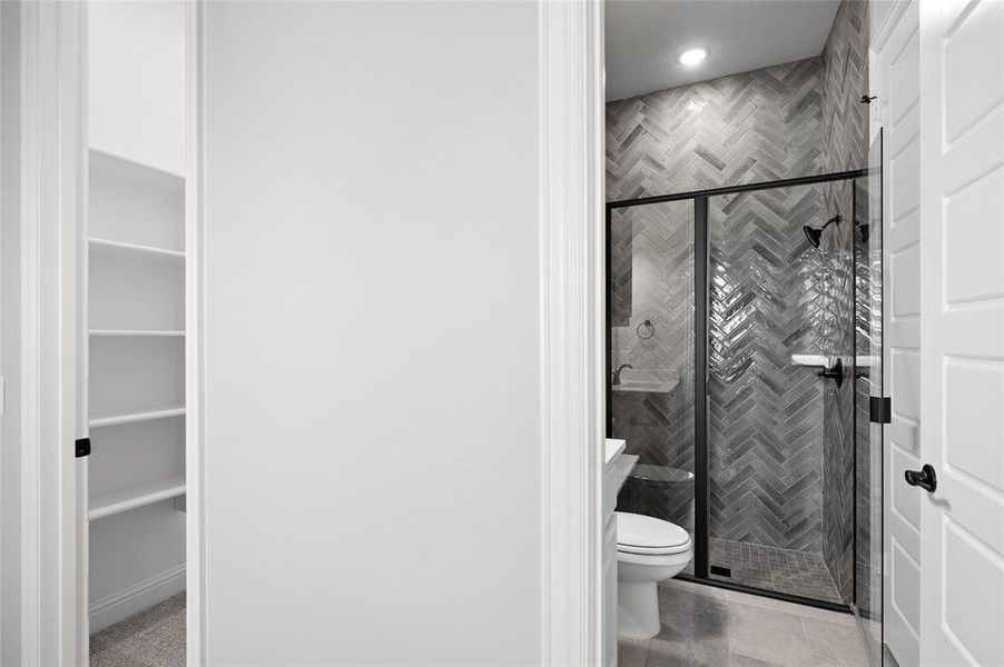 Bathroom featuring a stall shower and light tile patterned flooring