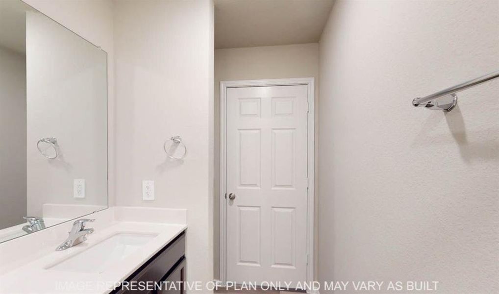 Bathroom vanity featuring a chrome faucet, integrated rectangular sink, and light-toned countertop Bathroom vanity featuring a chrome faucet, integrated rectangular sink, and light-toned countertop