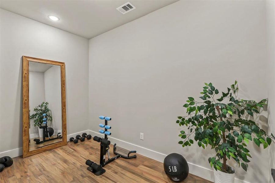 Workout room featuring wood finished floors and recessed lighting Workout room featuring wood finished floors and recessed lighting