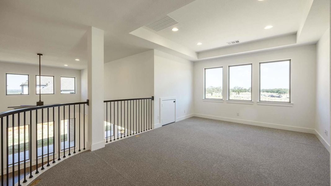 Empty room featuring carpet floors, a tray ceiling, and recessed lighting Empty room featuring carpet floors, a tray ceiling, and recessed lighting