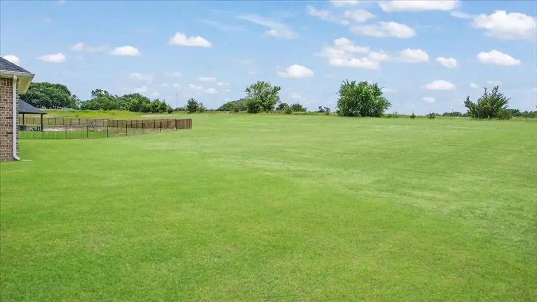 Backyard facing SE. There is a large ranch behind this property.