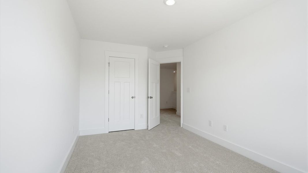 First-class secondary bedroom with comfortable carpeted flooring and generous closet space in Piedmont, SC