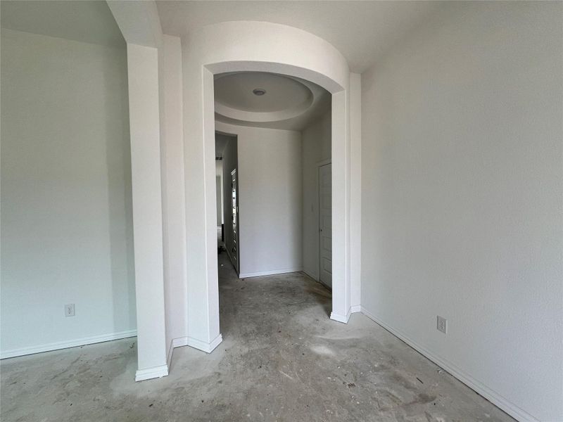 Spare room featuring concrete flooring and arched walkways