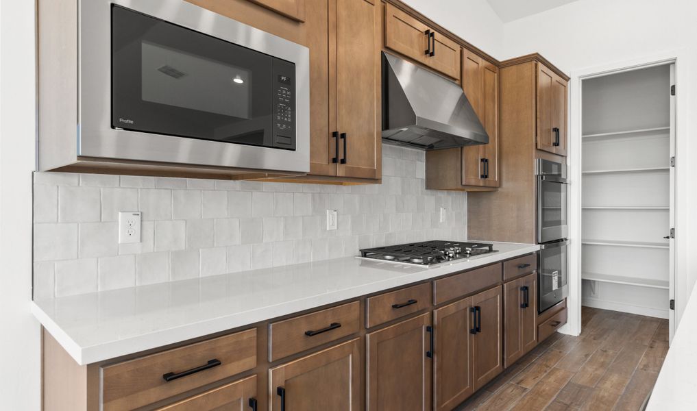 Kitchen with sleek stainless-steel vent hood Kitchen with sleek stainless-steel vent hood