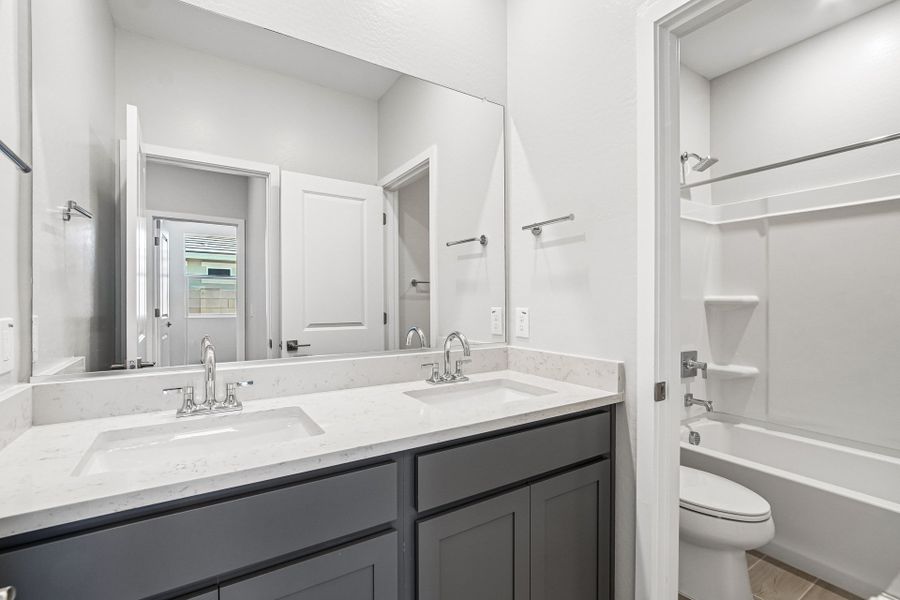 A bathroom with a sink and a toilet.