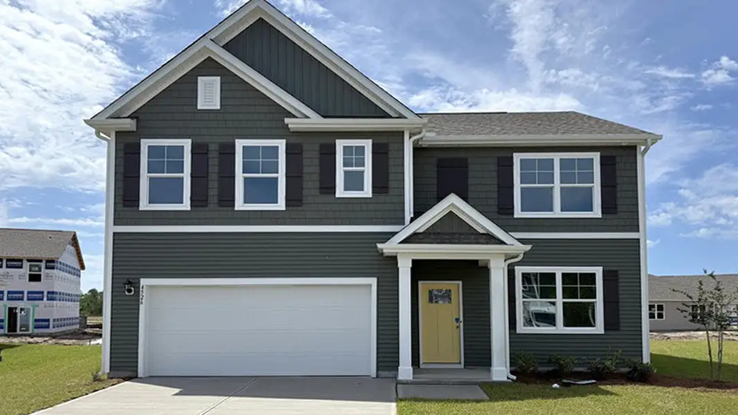 Front exterior of a new home in Sidbury Station, Castle Hayne, NC, highlighting curb appeal (Image 1). Front exterior of a new home in Sidbury Station, Castle Hayne, NC, highlighting curb appeal (Image 1).