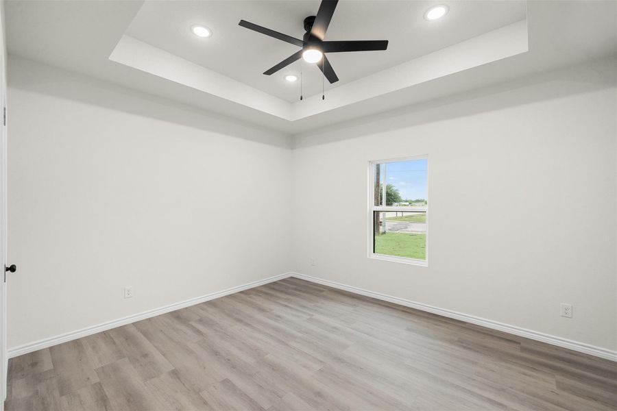 Recessed lighting and a modern ceiling fan illuminate this well-appointed room, offering comfort and style. Recessed lighting and a modern ceiling fan illuminate this well-appointed room, offering comfort and style.