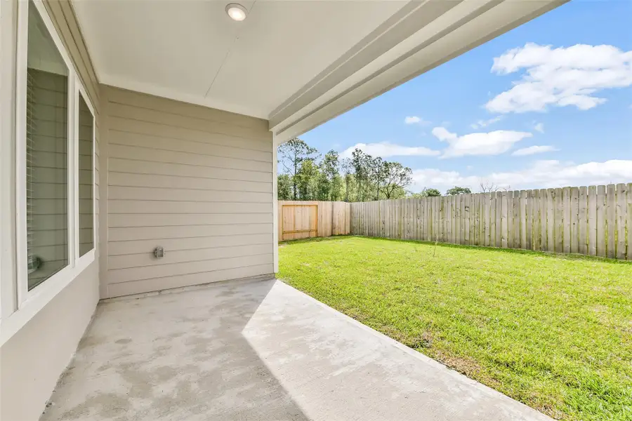 Exterior details and patio area of a home in King Oaks Village, Baytown (Image 4).