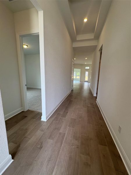 Hallway featuring dark wood-type flooring, baseboards, and recessed lighting Hallway featuring dark wood-type flooring, baseboards, and recessed lighting