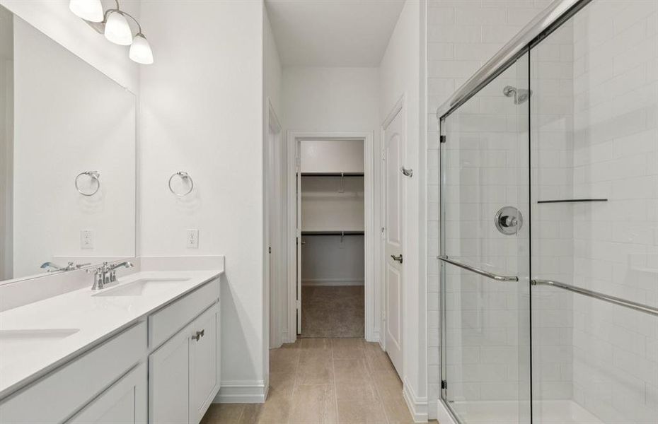 Luxurious owner's bath complete with double sinks and a generous shower  *Real home pictured