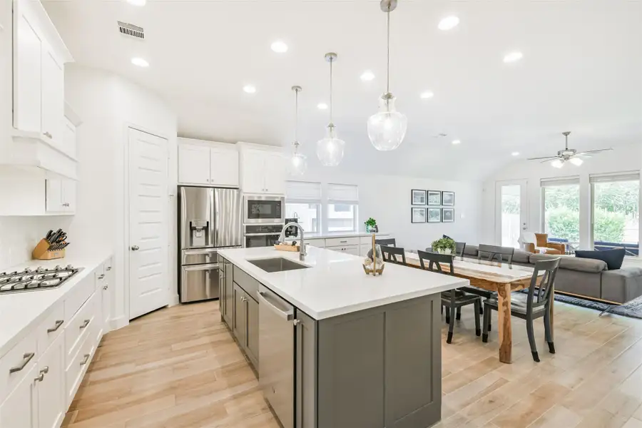 Island with double storage, wide counters, and breakfast bar is a beautiful accent in this generous kitchen. Island with double storage, wide counters, and breakfast bar is a beautiful accent in this generous kitchen.