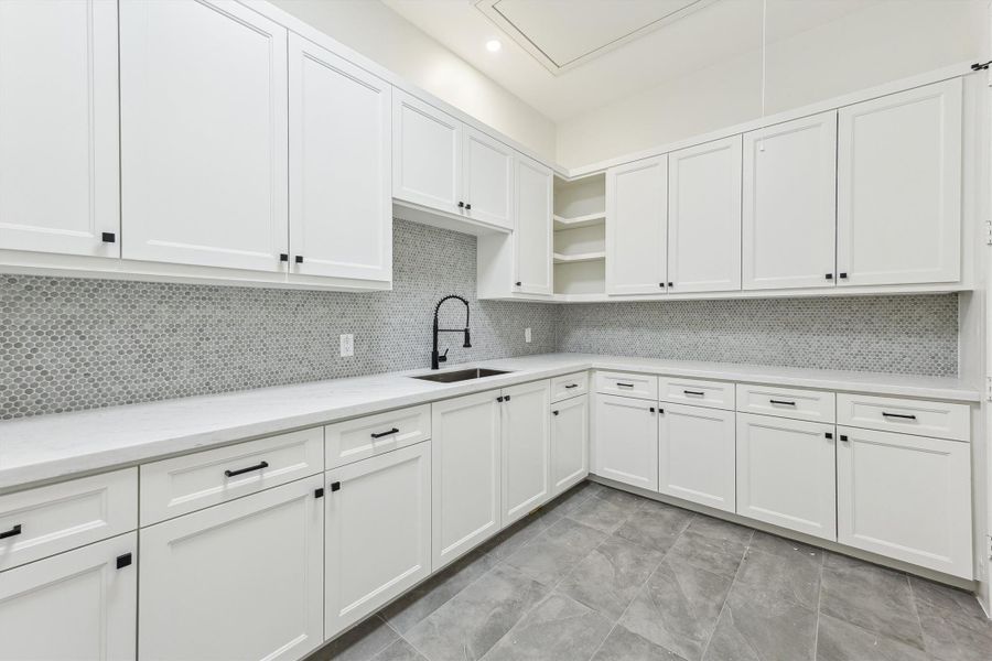 Utility room on th second floor - featuring custom built-ins and a sink.